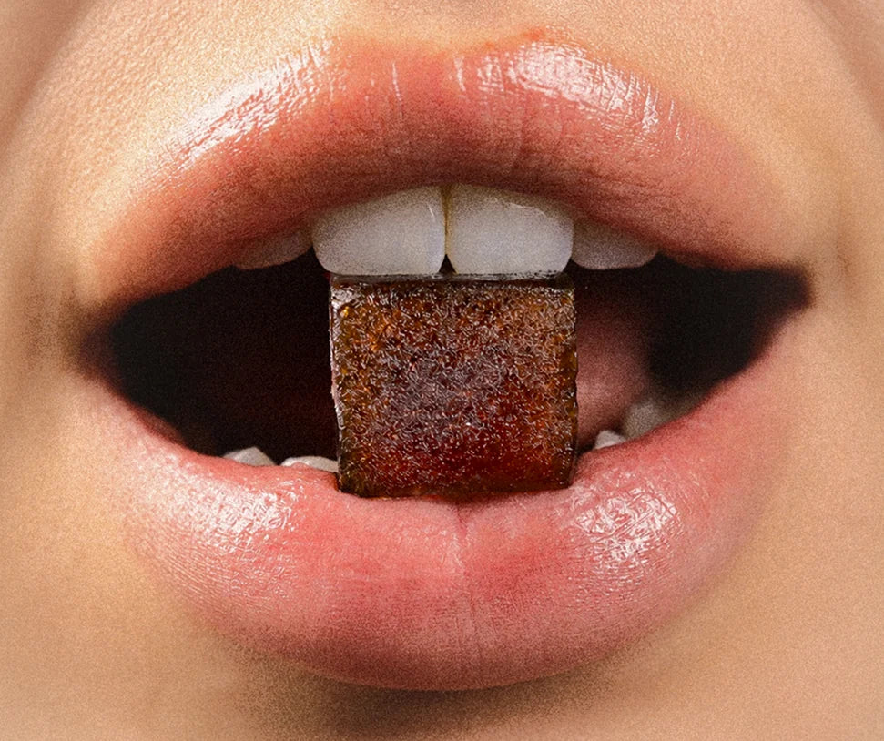 Close-up of a Tempo gummy between teeth
